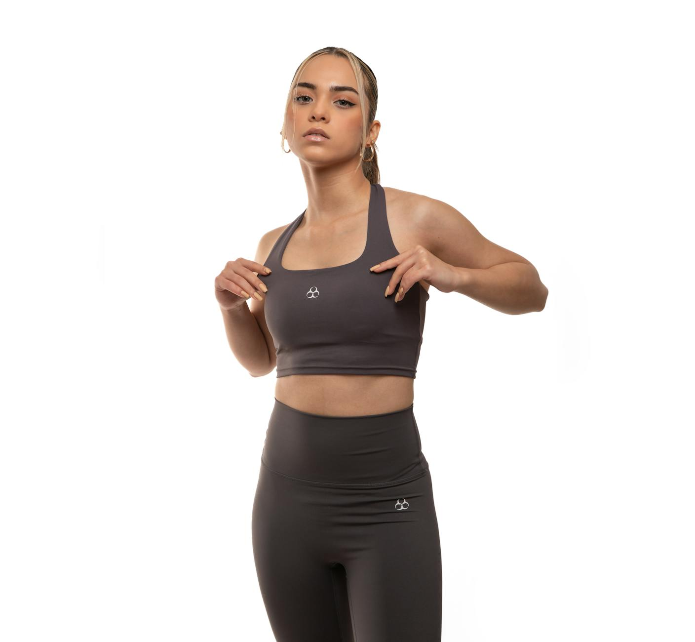 confident woman in stylish activewear studio shoot